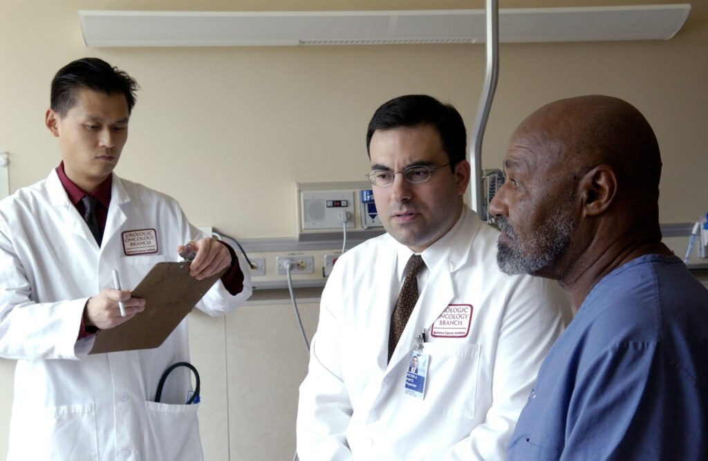 Doctors reviewing medical information with a patient in a clinical setting
