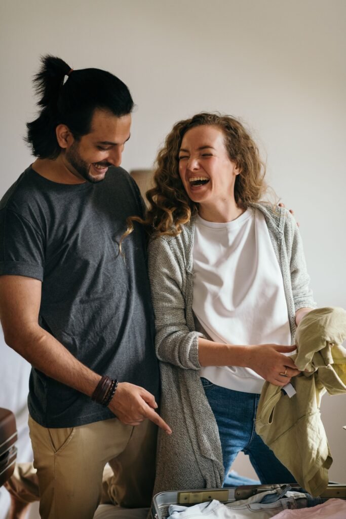 Couple packing suitcases at home before a holiday journey