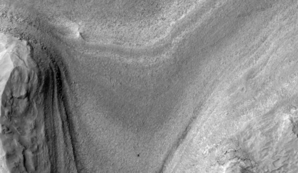 NASA Curiosity rover viewed from orbit on the slopes of Mount Sharp on Mars
