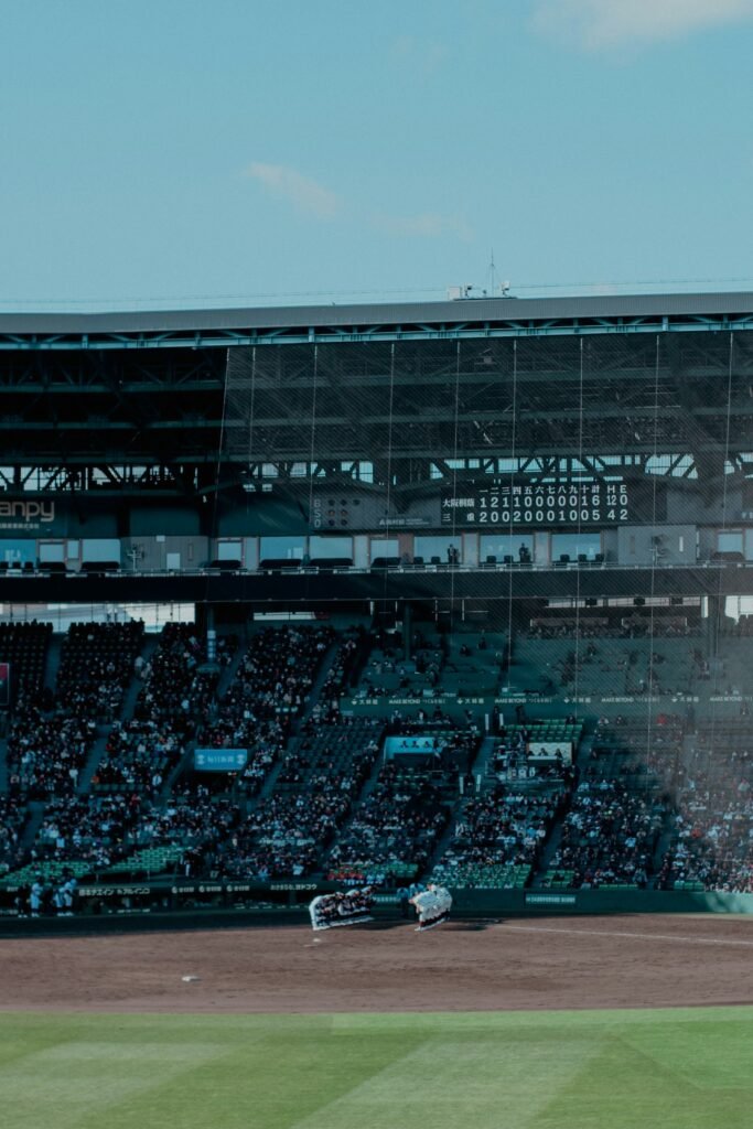 Baseball stadium filled with spectators under a clear sky