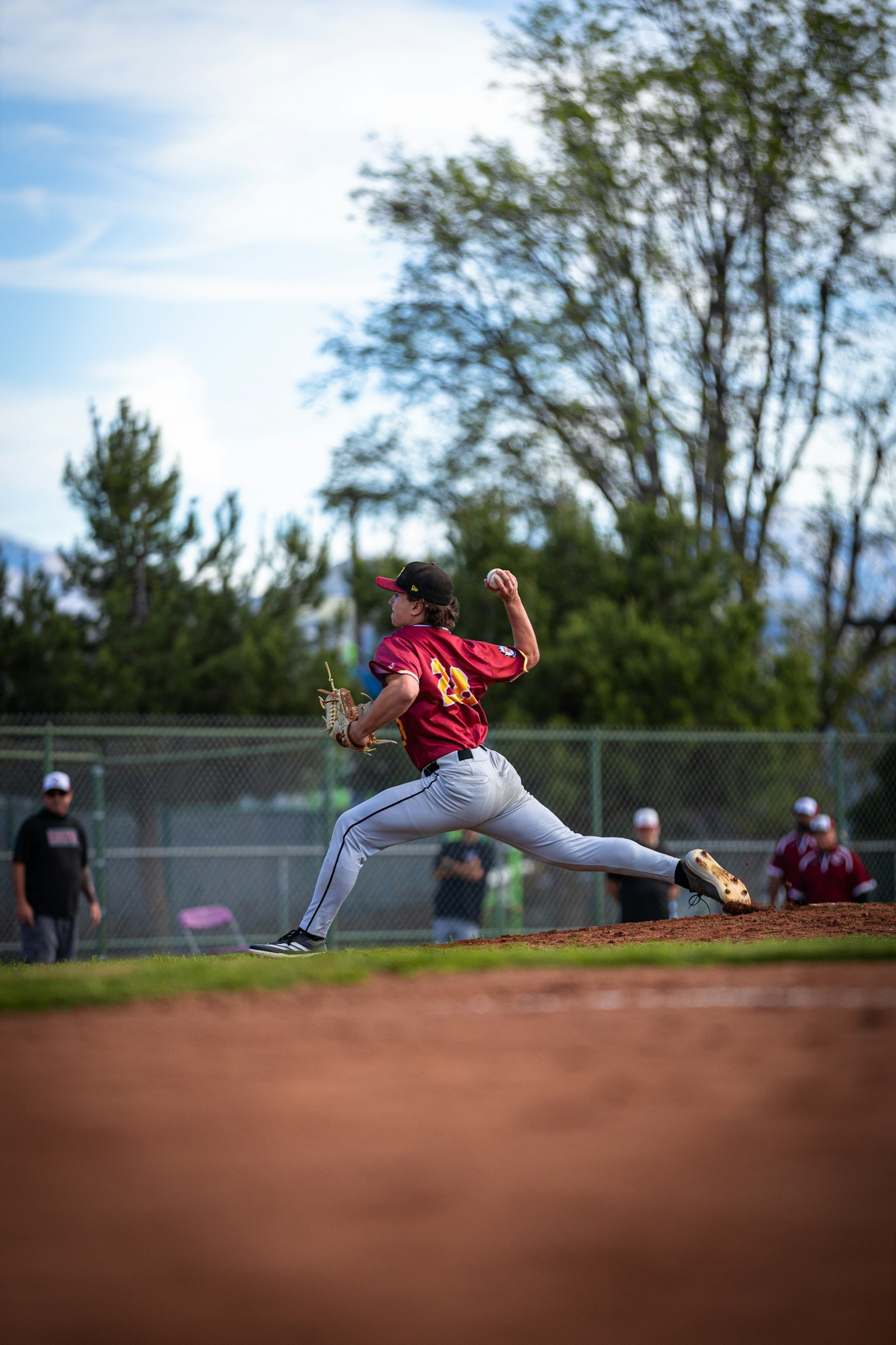 Baseball pitcher delivering a pitch during a game