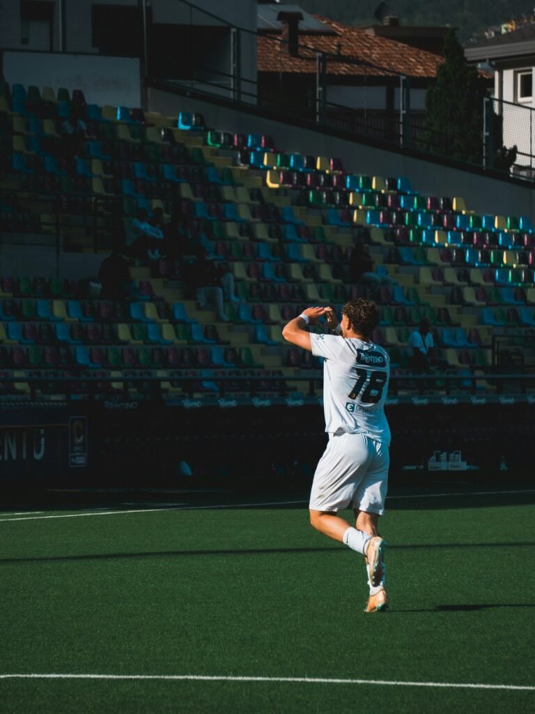 Soccer player celebrating on a green field