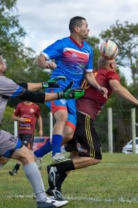 Soccer players jumping to compete for the ball