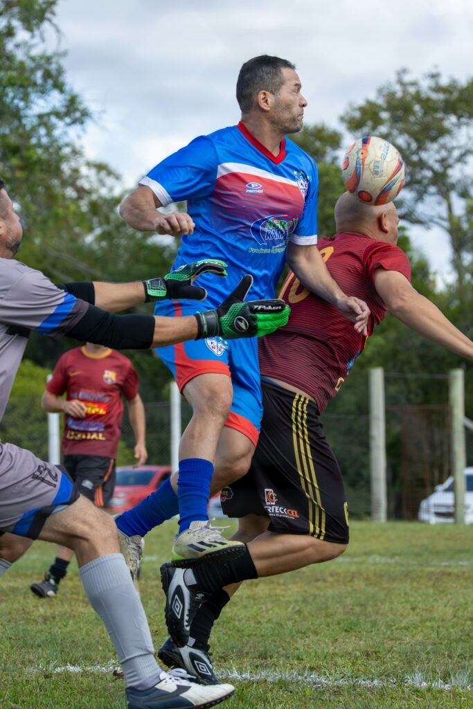 Soccer players jumping to compete for the ball