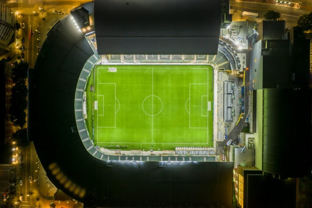 Soccer stadium at night with a green field