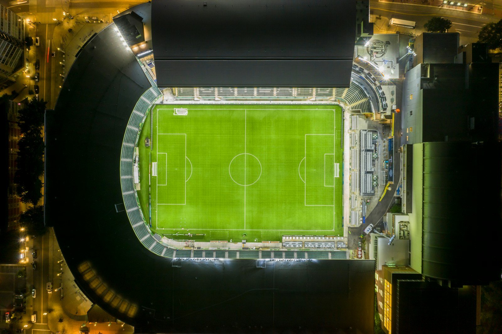 Soccer stadium at night with a green field