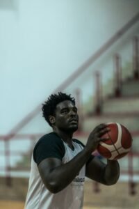Basketball player holding a ball indoors