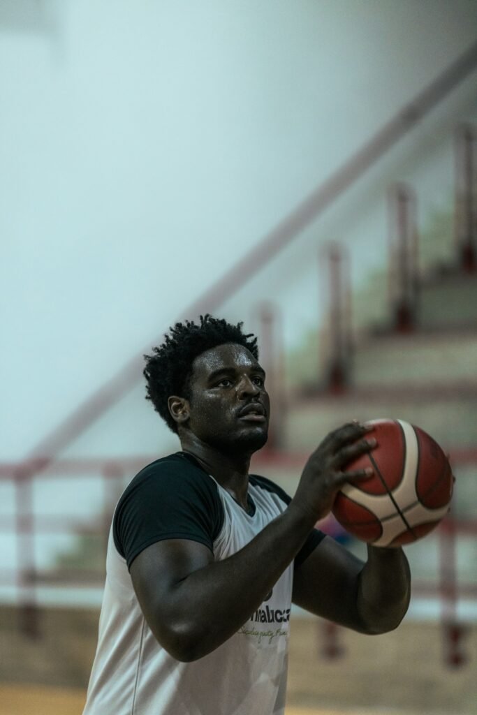 Basketball player holding a ball indoors