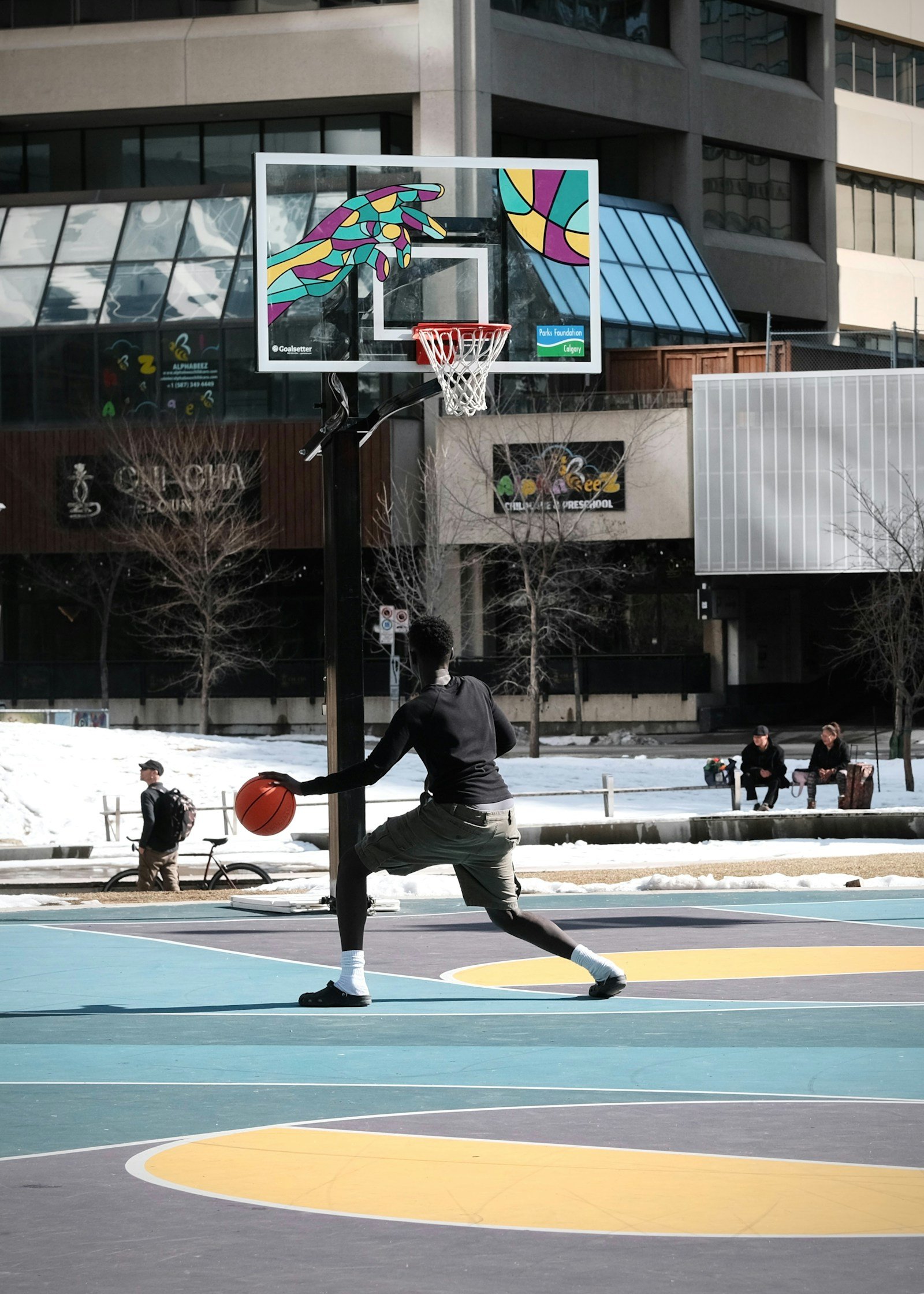 Basketball player handling the ball on an outdoor court