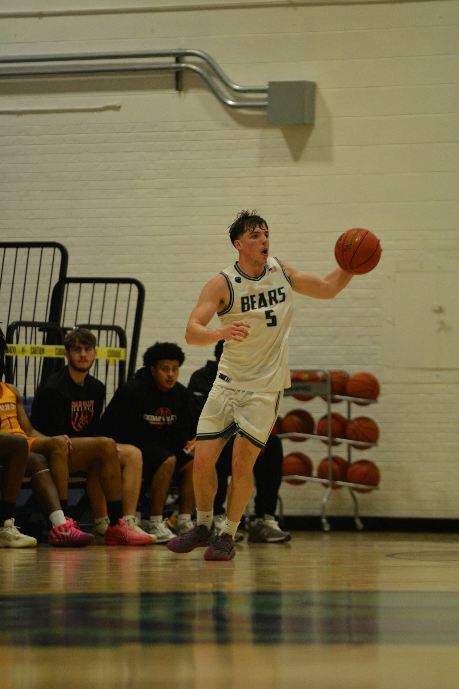Basketball player with the ball on an indoor court