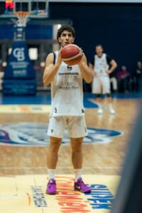 Basketball player holding a ball on a court