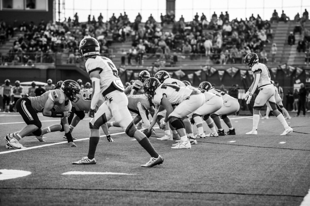 American football players gathered in a huddle on the field