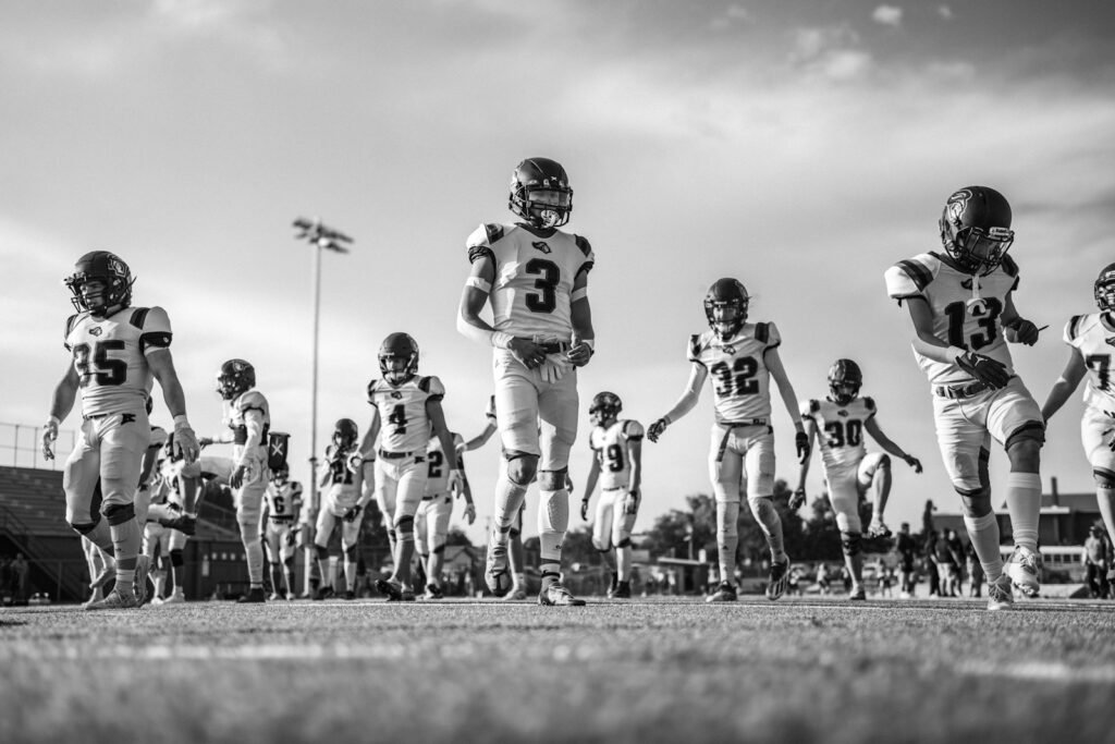 American football players running onto the field before a game