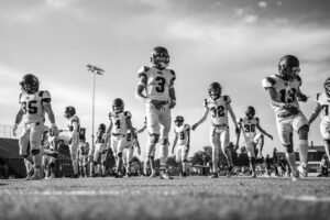 American football players running onto the field before a game