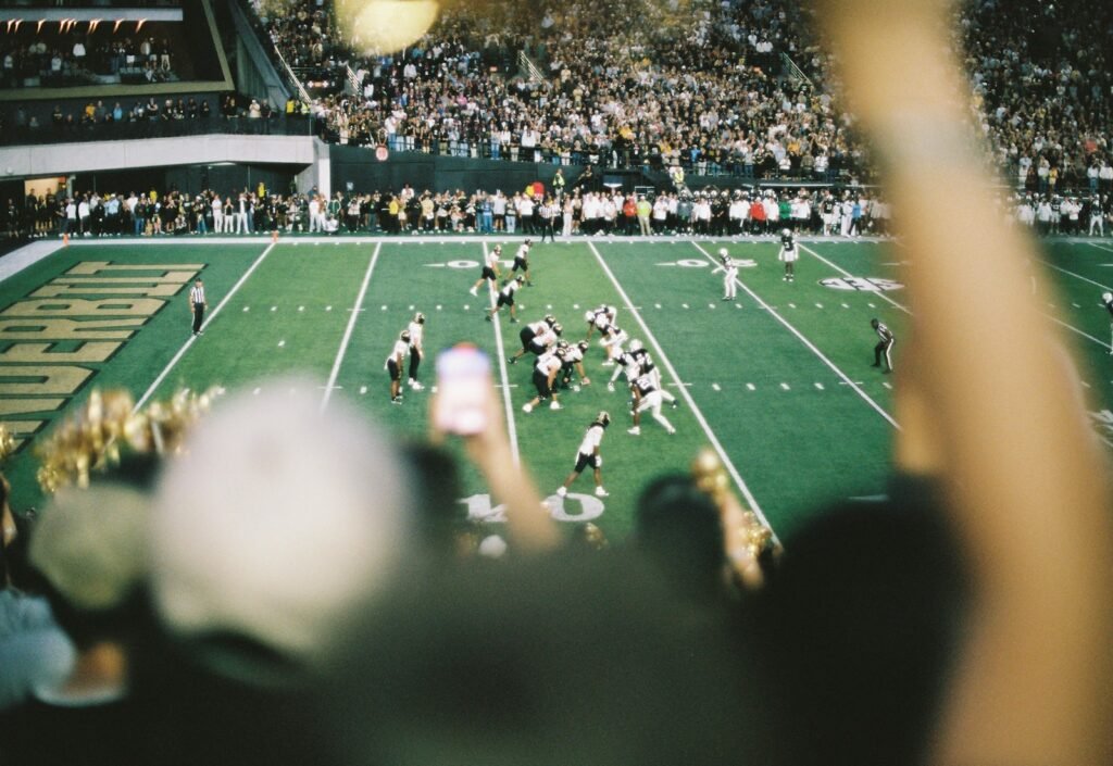 American football game in a crowded stadium