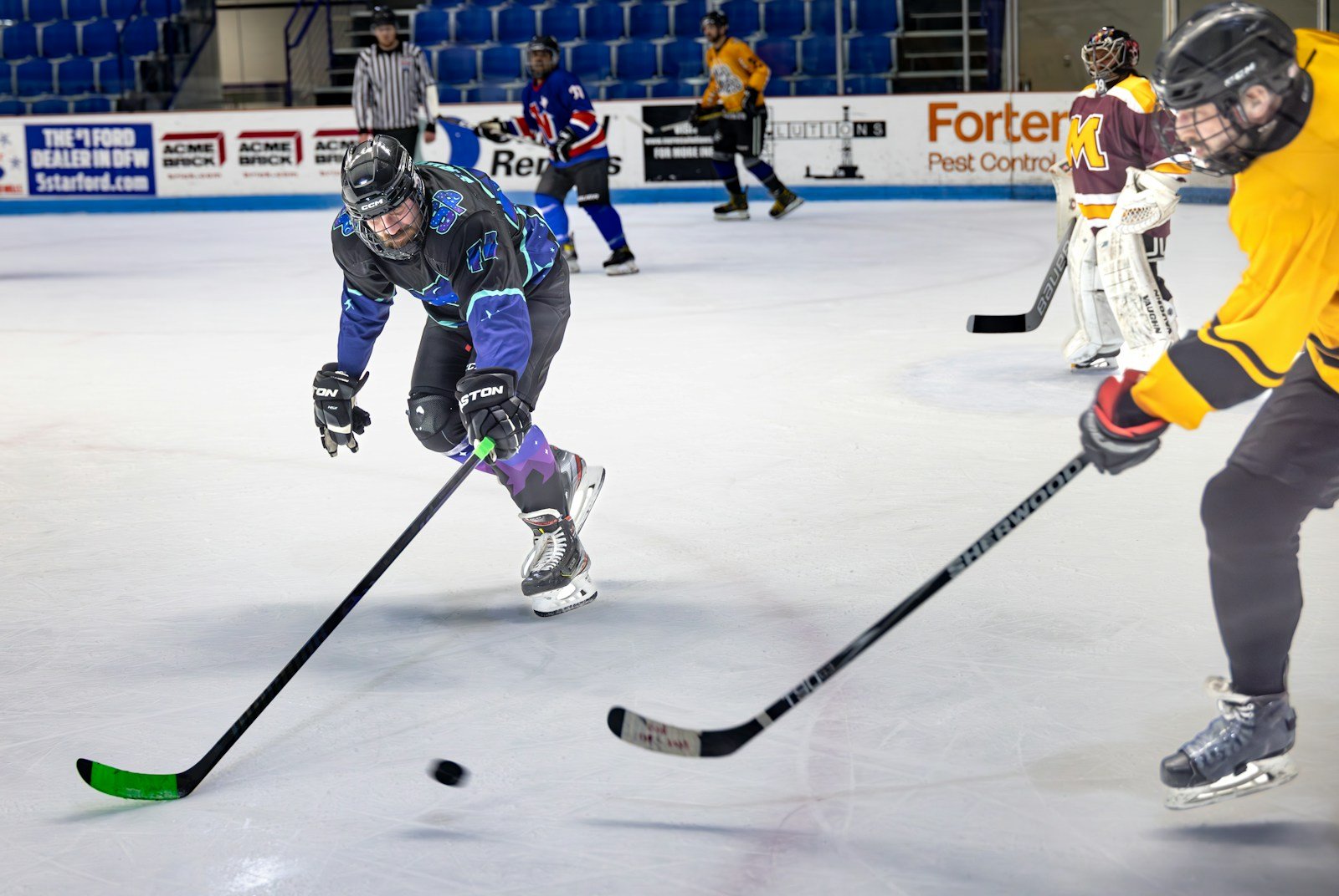 Hockey players competing on an ice rink