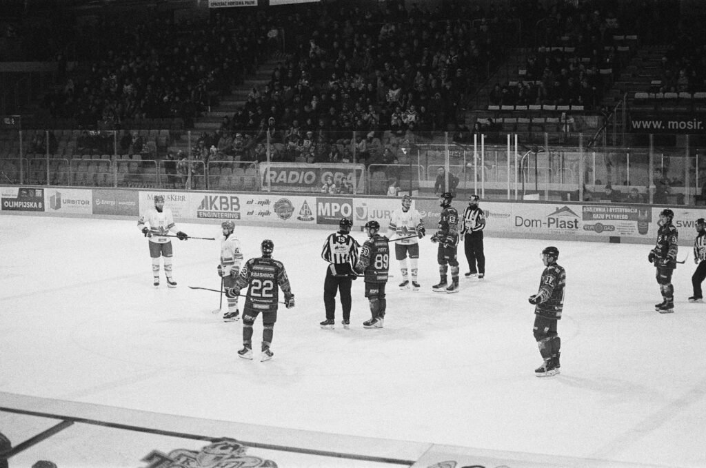 Hockey players and referees on an ice rink