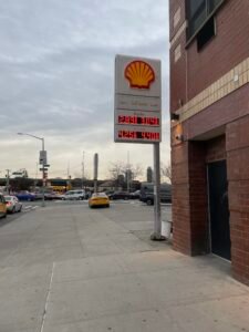 Gasoline price display in Manhattan illustrating household cost pressures