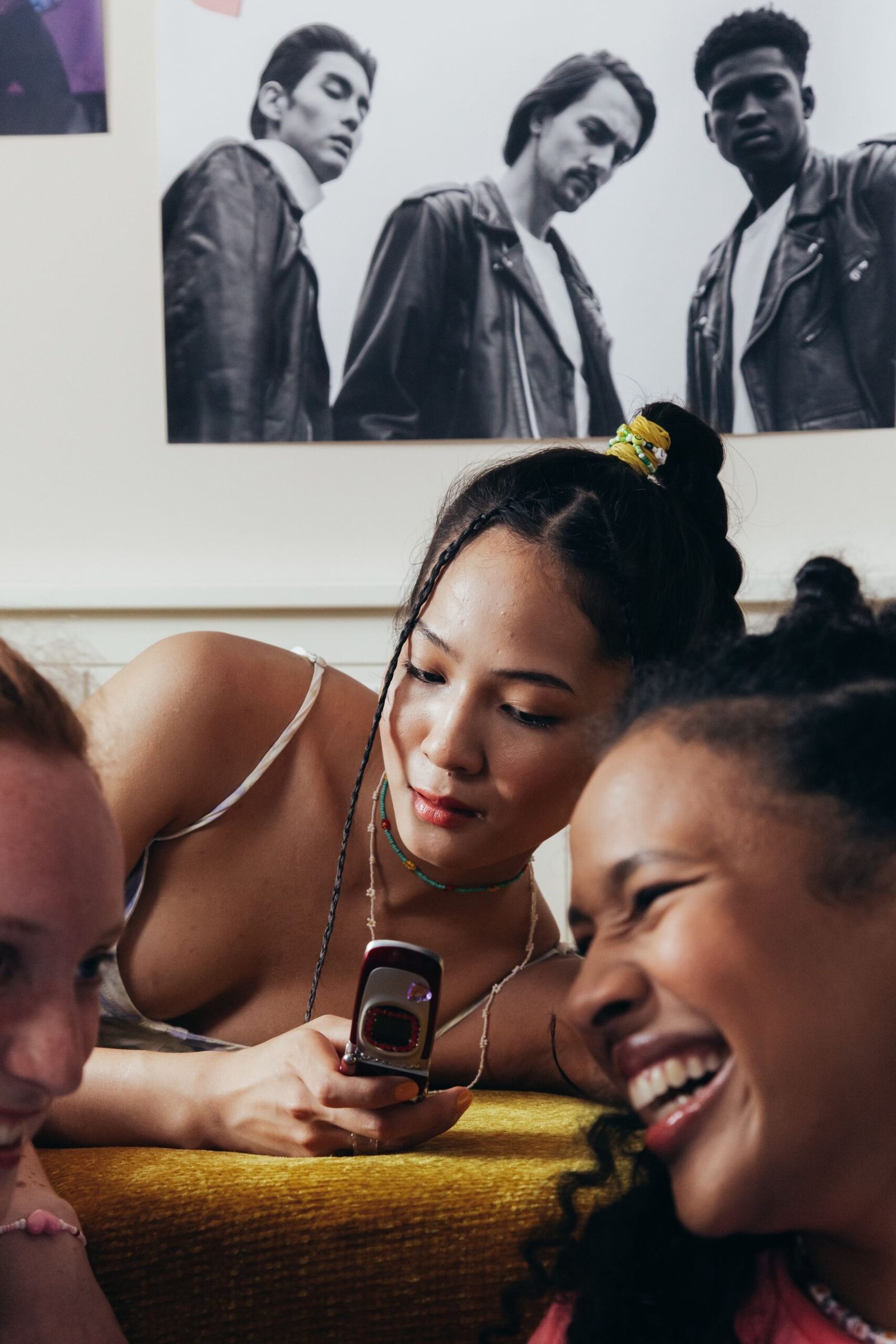 Teenagers using smartphones together indoors