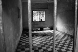 Prison cell interior representing federal criminal enforcement and sentencing