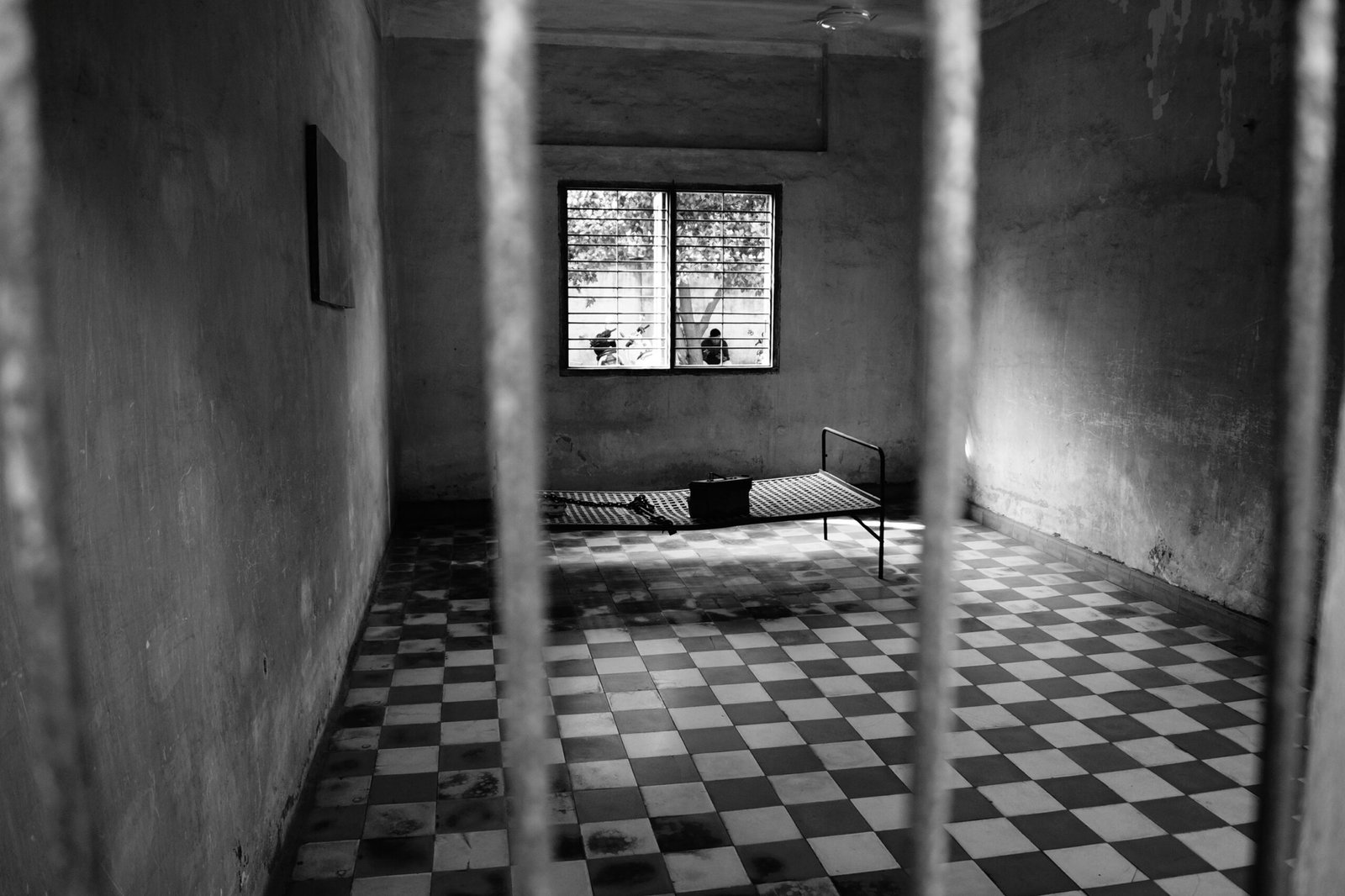 Prison cell interior representing federal criminal enforcement and sentencing