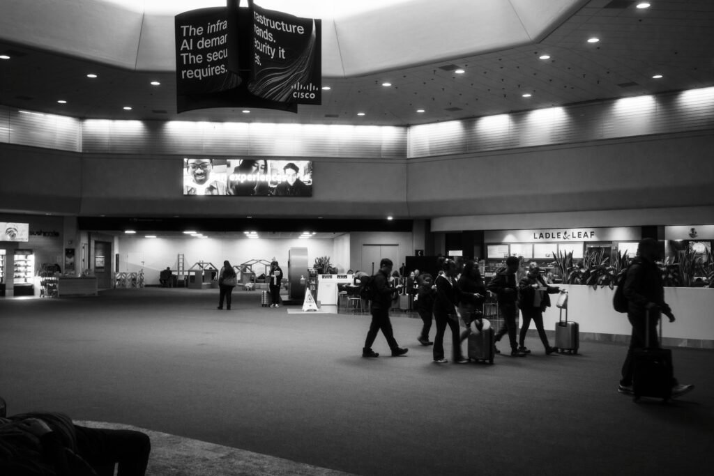 Travelers with luggage inside a modern U.S. airport terminal