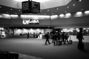Travelers with luggage inside a modern U.S. airport terminal